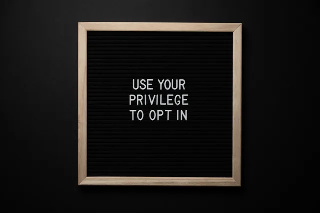 From above composition of contrast blackboard in wooden frame with white USE YOUR PRIVILEGE TO OPT IN title on black background. How Scottish subscription brands meet ICO and PECR consent rules